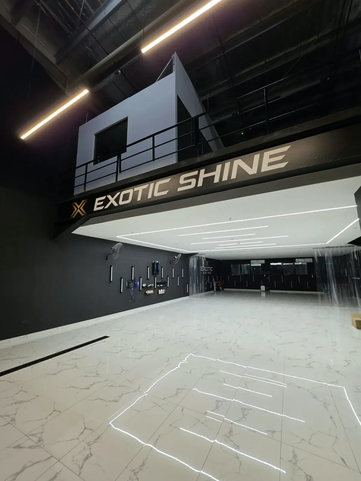 The lit hall under the mezzanine, with the Exotic Shine sign