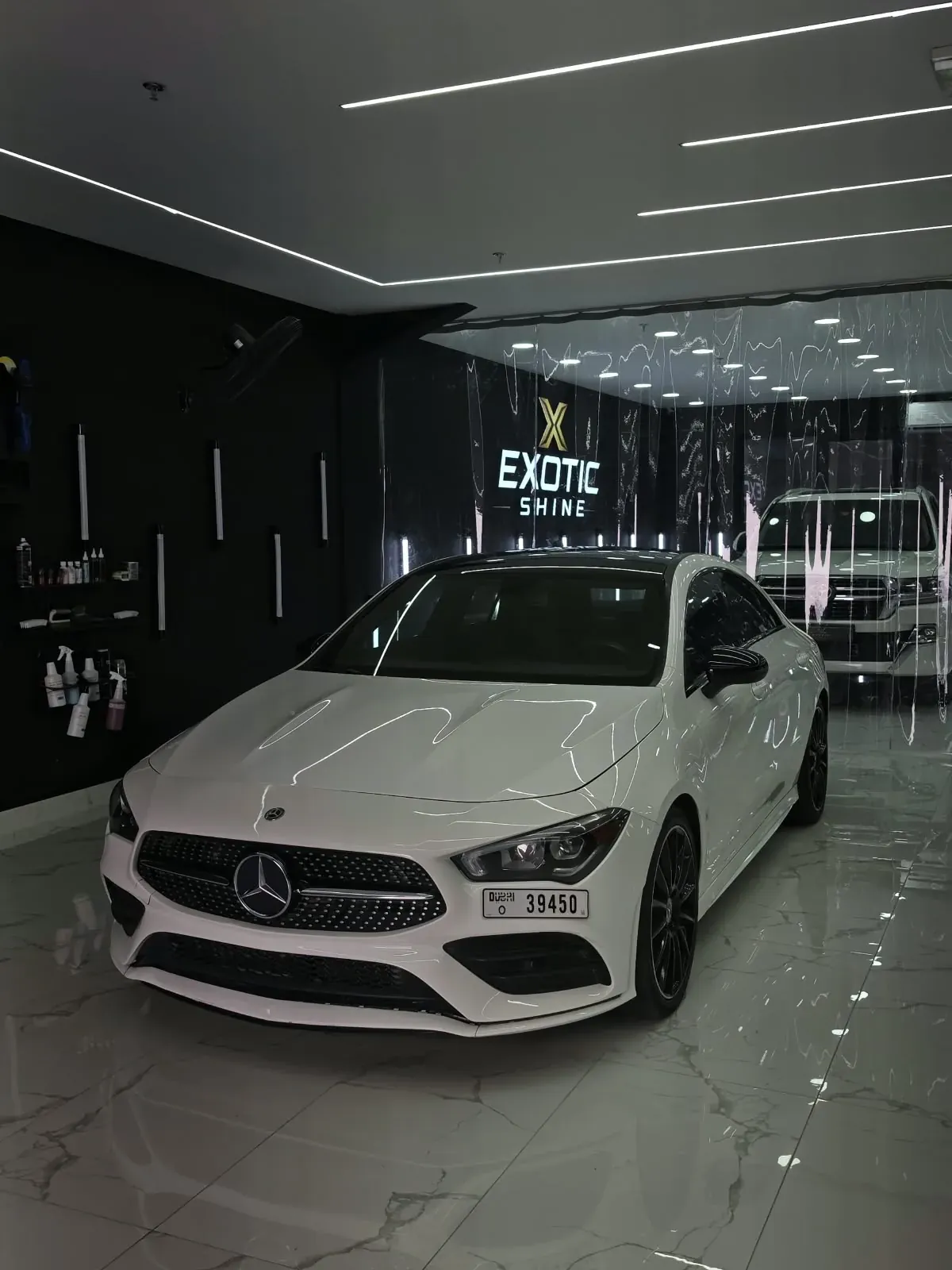 A Mercedes CLA on the marble floor in front of the Exotic Shine wall